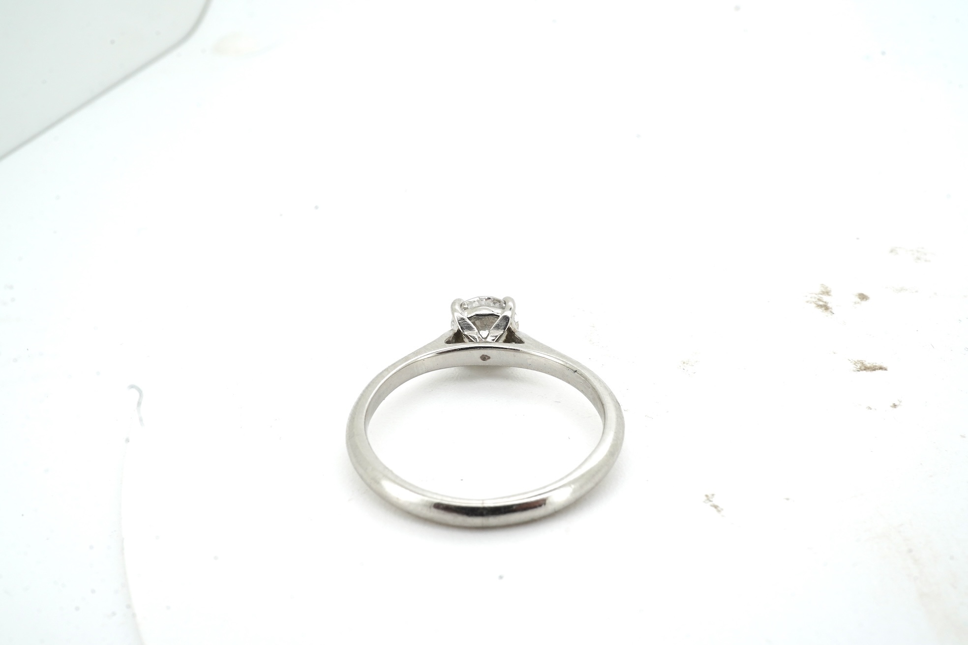 A diamond ring, claw-set with a brilliant-cut diamond weighing approximately 0.61 carats, mounted in platinum, size L, British hallmarks, gross weight approximately 3 grams